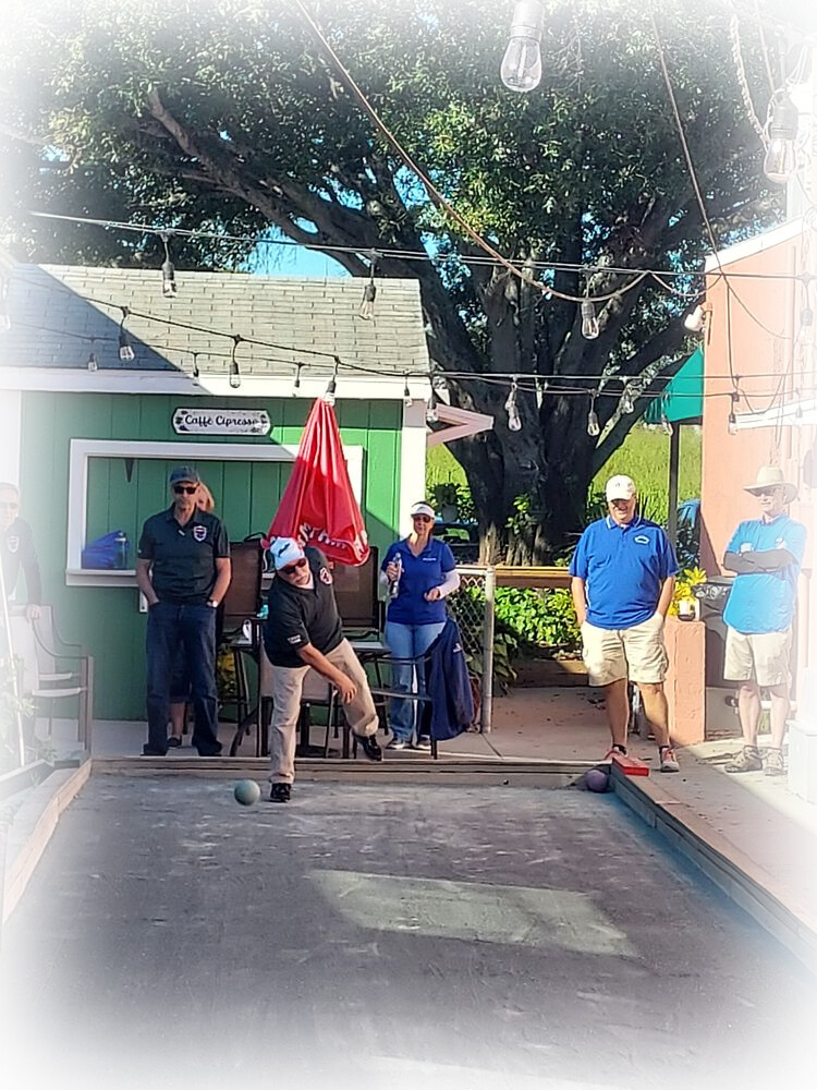 Bocce league players and spectators on the courts